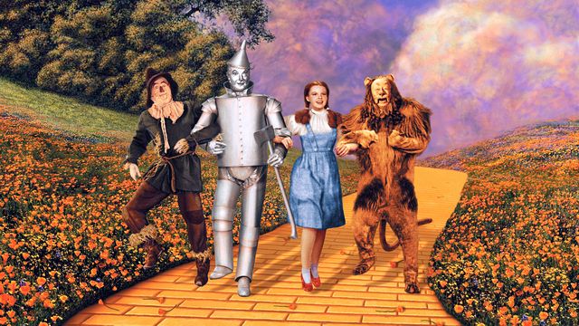 'Wizard of Oz' film: Tin Man, Scarecrow, Dorothy & Cowardly Lion on the Yellow Brick Road.