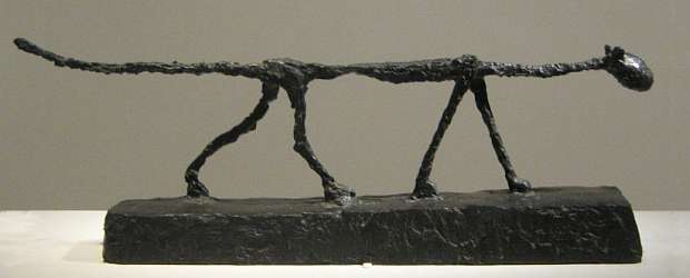 Sculpture of a prowling skinny cat, by Alberto Giacometti.