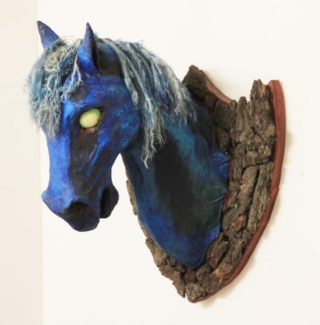 Horse head hung on bark; papier-mache dream sculpture by Mardi Storm.