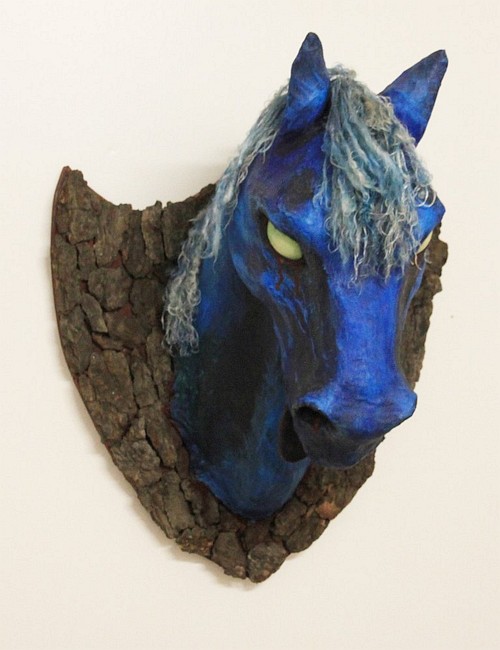 Horse head hung on bark; papier-mache dream sculpture by Mardi Storm.