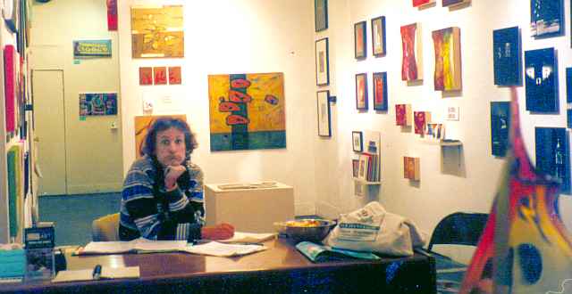 photo of Chris Wayan at desk of City Art Gallery, Valencia Street, San Francisco, in 2004.