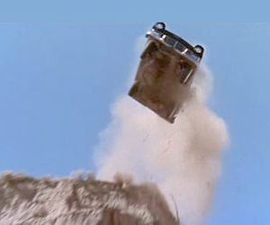Stunt car goes over a cliff.