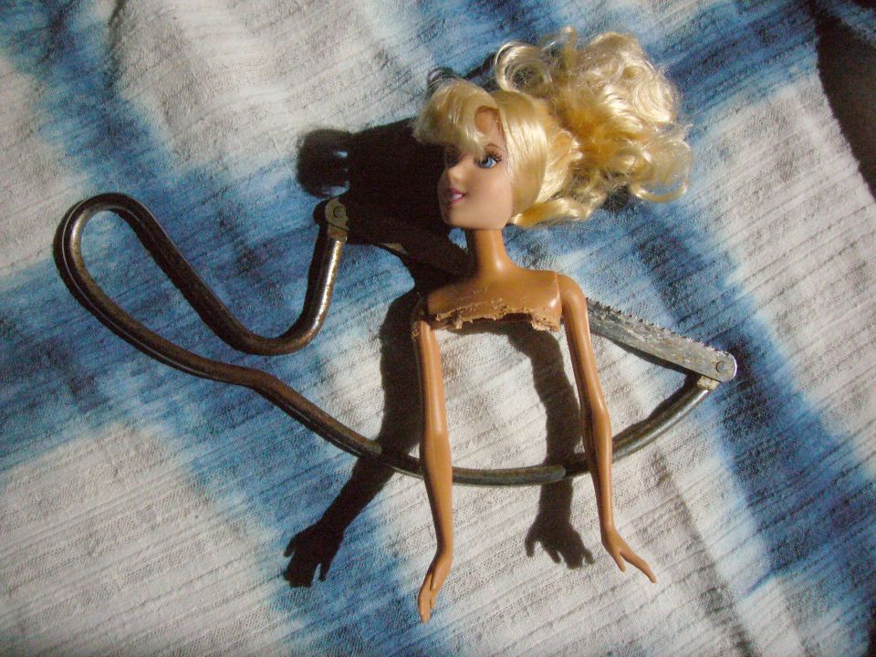 Severed Barbie head and arms, a tragic byproduct of sculpting.