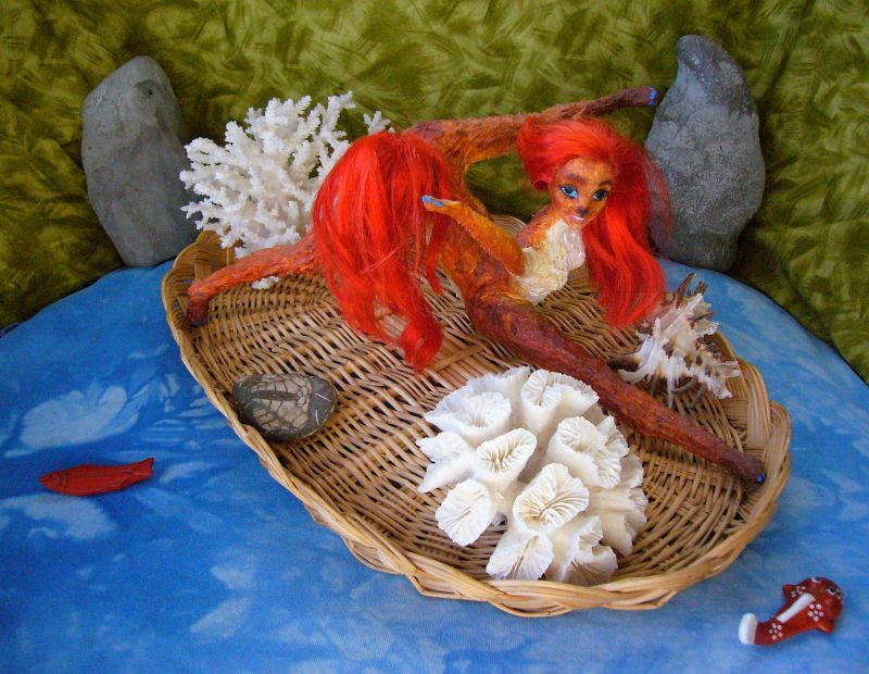 Ariel, a redheaded redtailed centauroid, on a woven reed raft collecting coral; Pem Sish Islands on Kakalea, a model of a dryish Earthlike world. Click to enlarge.