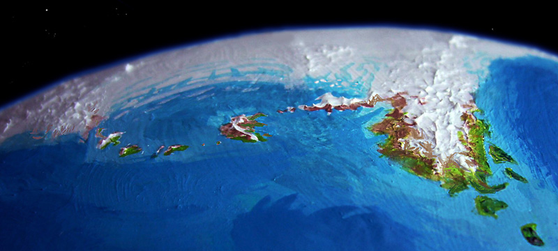 Low orbital photo of the Grass Islands and Kogmi Peninsula off Sia, the antarctic continent on Kakalea, a model of an Earthlike world with a desert problem.