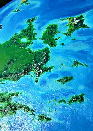 Orbital photo of the rugged Cromdhu Islands and northeast Troisleons, a continent on Lyr, a world-building experiment. Troisleons is a temperate continent smaller than South America.