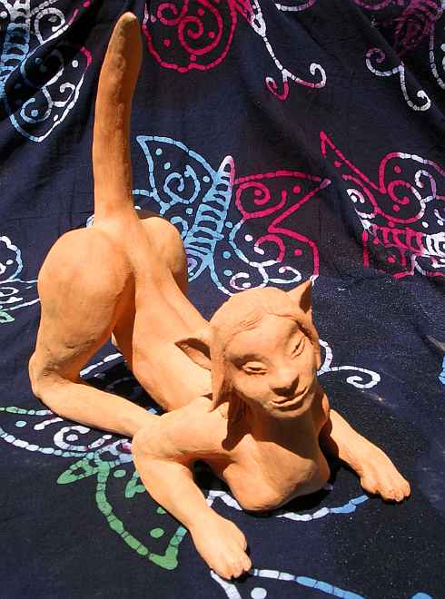 Sphinx crouching, from right side; unfired clay sculpture.  Click to enlarge.