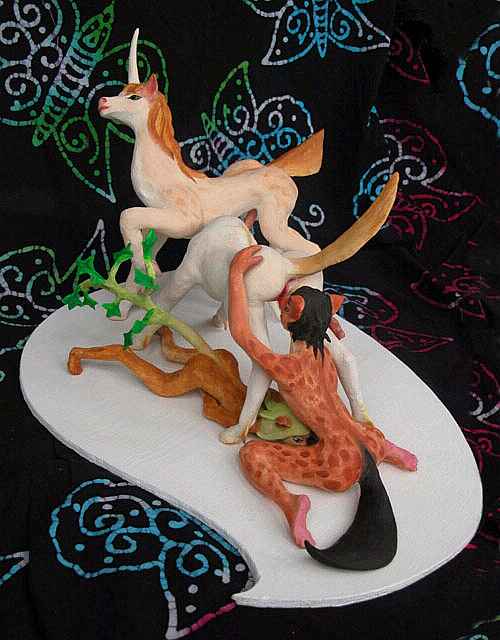Two unicorns, a dryad and a wolf-satyr making love: painted sculptures. Click to enlarge.