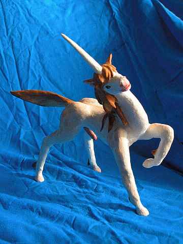 A randy unicorn stallion pawing and tilting his head: painted sculptures. Click to enlarge.