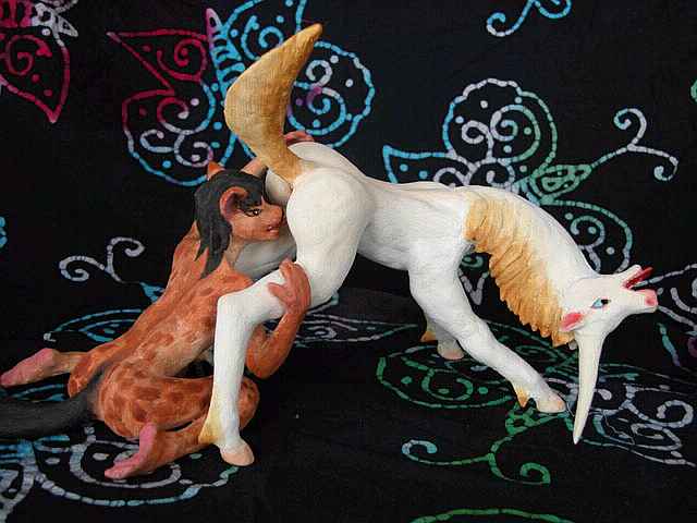 A wolf-satyr licking a unicorn mare: painted sculptures. Click to enlarge.