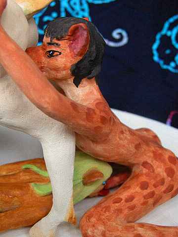 A dryad licks a wolf-satyr who licks a unicorn mare: painted sculptures.