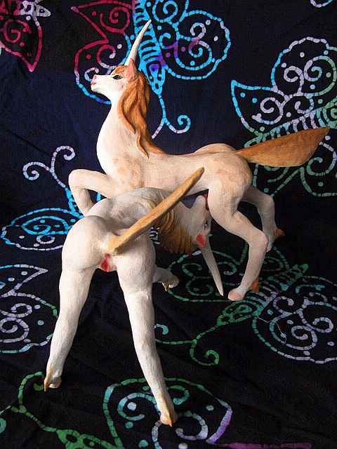 A unicorn mare licking a stallion: painted sculptures. Click to enlarge.