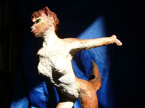 Sculpture of a dream by Chris Wayan: a wolf dancer about 25 cm tall (10 in.) leaning forward, gesturing. Click to enlarge.