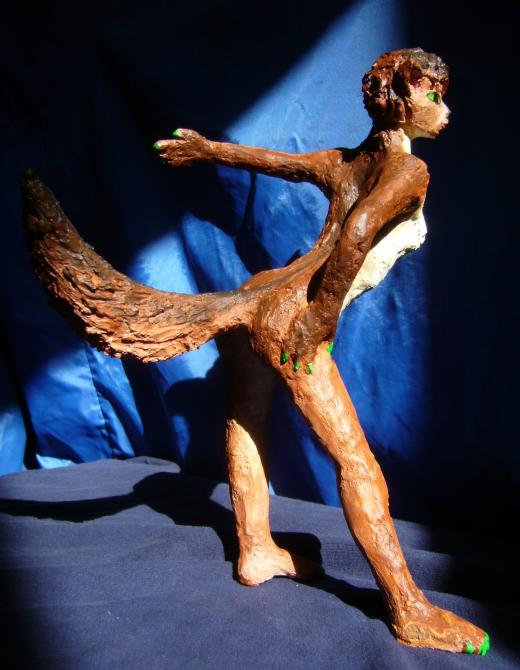 Sculpture of a dream by Chris Wayan: profile of a wolf dancer about 25 cm tall (10 in.). Click to enlarge.