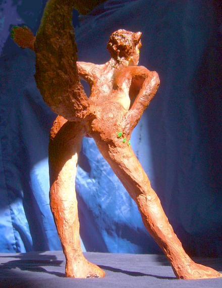 Sculpture of a dream by Chris Wayan: rear view of a wolf dancer about 25 cm tall (10 in.). Click to enlarge.