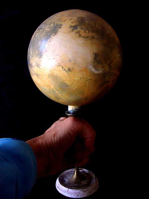 Globe of Xanadu by Chris Wayan. A 5-inch/12 cm sphere on a candlestick held in my hand. Xanadus a slightly larger, wetter Titan sustaining life in ethane seas.